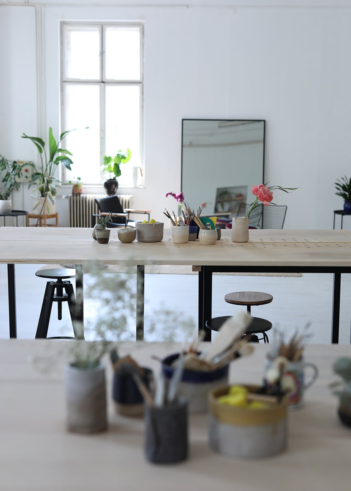 Modern office space with a long wooden table and decorative items.